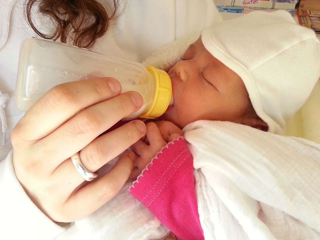 bottle feeding a newborn baby