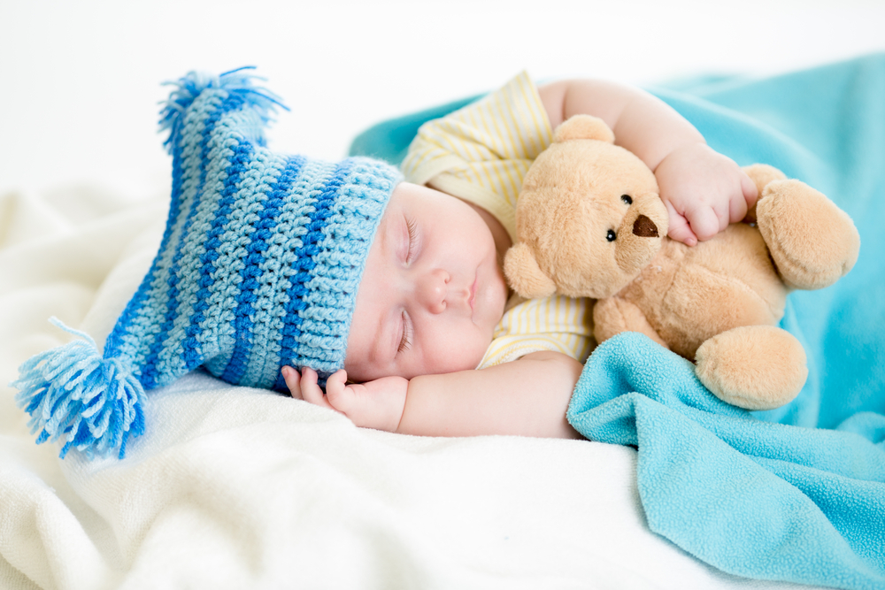 baby sleeping with teddy